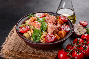 Delicious fresh pasta with meatballs, sauce, cherry tomatoes and basil