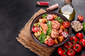 Delicious fresh pasta with meatballs, sauce, cherry tomatoes and basil