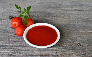 Ketchup on a gray wooden board, food preparation concept