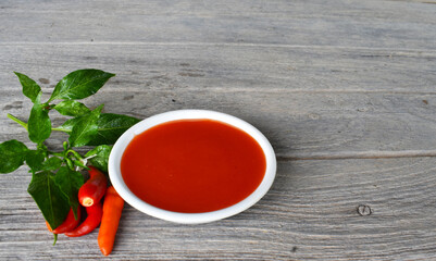 chilli sauce on a gray wooden board, food preparation concept