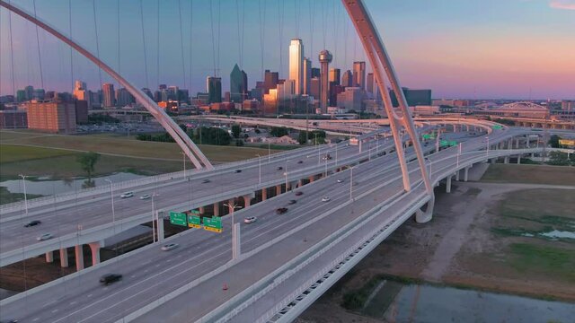 Aerial: Traffic crossing the Margaret Mcdermott Bridge over the Trinity River & downtown Dallas at night. Texas, USA