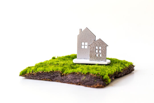 miniature house with red roof on green grass isolate on white background, Image for property real estate investment concept.