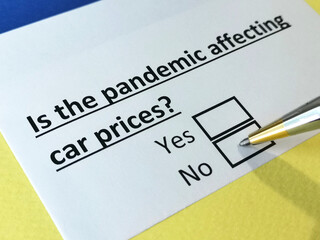 Obraz premium One person is answering question about pandemic effects on car prices.