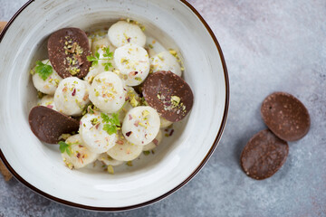 Bowl of vareniki or curd dumplings over beige stone background, view from above, horizontal shot