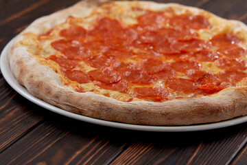 tasty pizza on the wooden background