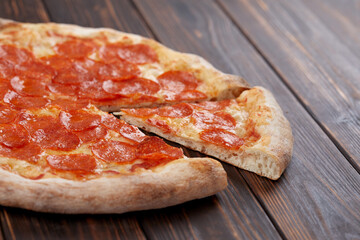 tasty pizza on the wooden background