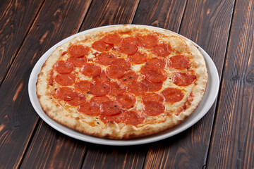 tasty pizza on the wooden background