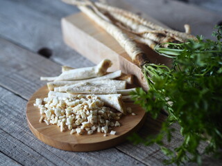 Medical and food background.Parsley and parsley root on a wooden background.Useful plant.