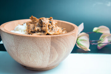 Fried pork with garlic and pepper in a wooden bowl