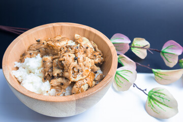 Fried pork with garlic and pepper in a wooden bowl