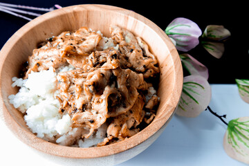 Fried pork with garlic and pepper in a wooden bowl