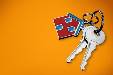 House shaped keychain and keys on desk