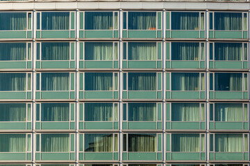 Fototapeta na wymiar windows of office building in vintage style with curtain
