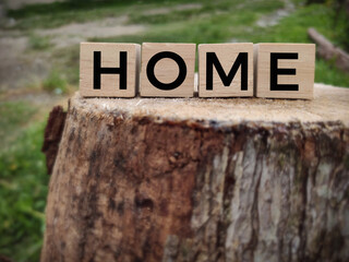 HOME text on wooden blocks in vintage background. Stock photo
