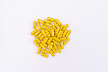 yellow capsules on a white background, pills for health, antibiotics against parasites, yellow powder in the package, tablets for illness and pain