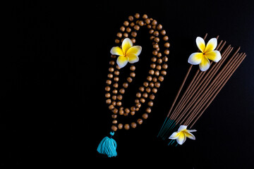 beads for meditation, sacred tulasi tree, things for spiritual practice on a black background,...