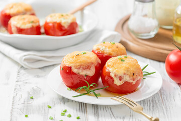 Tomatoes stuffed with rice and vegetables, baked with cheese . Vegetarian food.