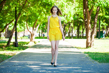 Portrait of a young beautiful blonde girl in yellow dress