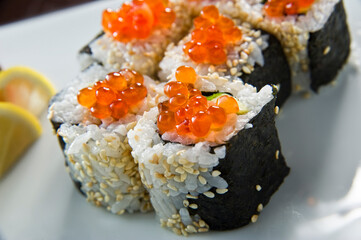 Sushi roll with salmon and shrimp tempura.