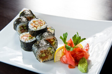 Sushi roll with salmon and shrimp tempura.