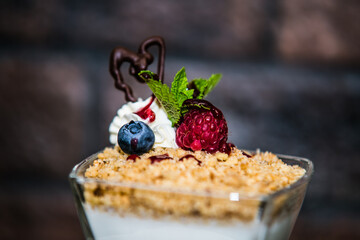 Delicious sweet dessert with different fresh fruit and cream. Closeup.