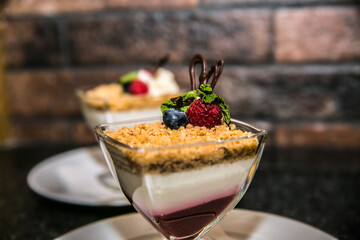 Delicious sweet dessert with different fresh fruit and cream. Closeup.