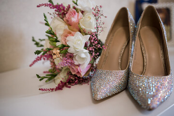 wedding gold rings with bride shoes and decor