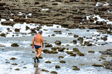 Man running on the beach during outflow