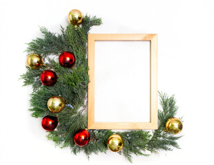Christmas frame juniper gold and red balls on white background top view.