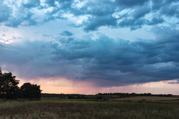 Landscape of a plain with a thunderstorm coming and thunderclouds in the overcast sky