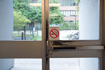 Non smoking sign in glass door