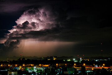 Naklejka premium Cloudy with Bright lightning bolt strikes in the rural landscape of small city and satellite station