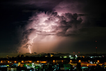 Cloudy with Bright lightning bolt strikes in the rural landscape of small city and satellite station