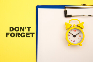 Don't forget - reminder on yellow background with yellow alarm clock aside.