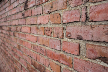 Detail of brown old brick wall seen laterally in rural area