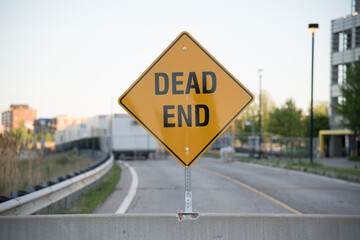 dead end sign with construction in background