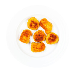 top view of portion of fried chicken nuggets on white plate isolated on white background