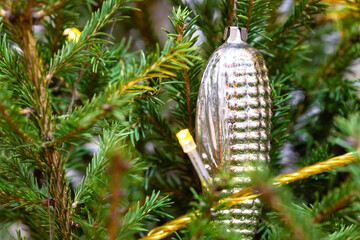 glass cone in twigs of natural christmas tree close-up indoor