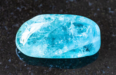 closeup of sample of natural mineral from geological collection - rolled Aquamarine (blue Beryl)...