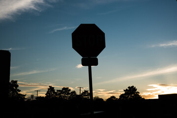 stop sign against sunset sky