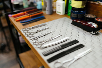 Set of hairdressing tools on table. Clean metal scissors