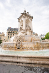 Fototapeta na wymiar Fountain near Church of Saint Sulpice in Paris.
