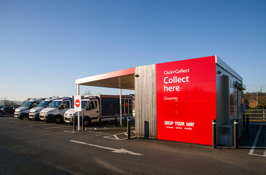 Swansea, UK: December 28, 2016: Tesco Click and Collect. Order shopping online and collect from a local store for free. Delivery vans are parked alongside. Illustrative Editorial 