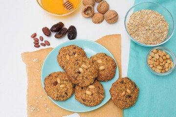 homemade oatmeal cookies with dates, peanuts, coconut shavings, macro close-up. broken cookies in the foreground. space for text.