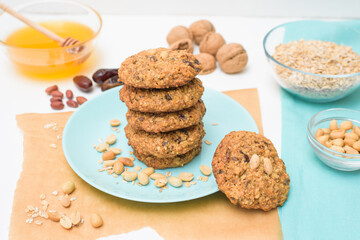 homemade oatmeal cookies with dates, peanuts, coconut shavings, macro close-up. broken cookies in the foreground. space for text.