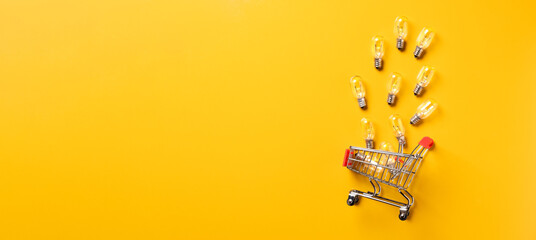 creativity content marketing concept,top view shopping cart with full of lightbulbs with on yellow...