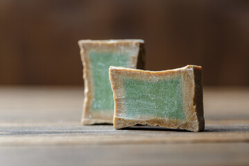 Two slices of traditional aleppo organic laurel soap.