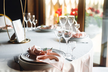 Close up festive table setting with empty wine glasses and plate