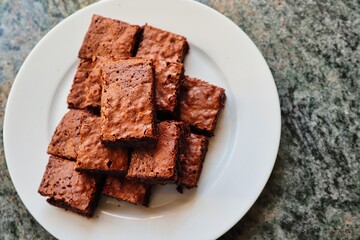 Homemade Gluten Free Brownies Served on White Plate. Brownies Top View made in the kitchen of Czech Republic.