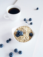 A cup of coffee, granola and blueberries. Morning still life.